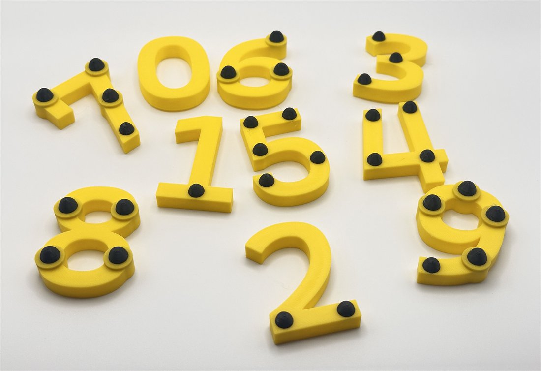 Yellow 3D-printed numbers 0-9 with raised black touch points